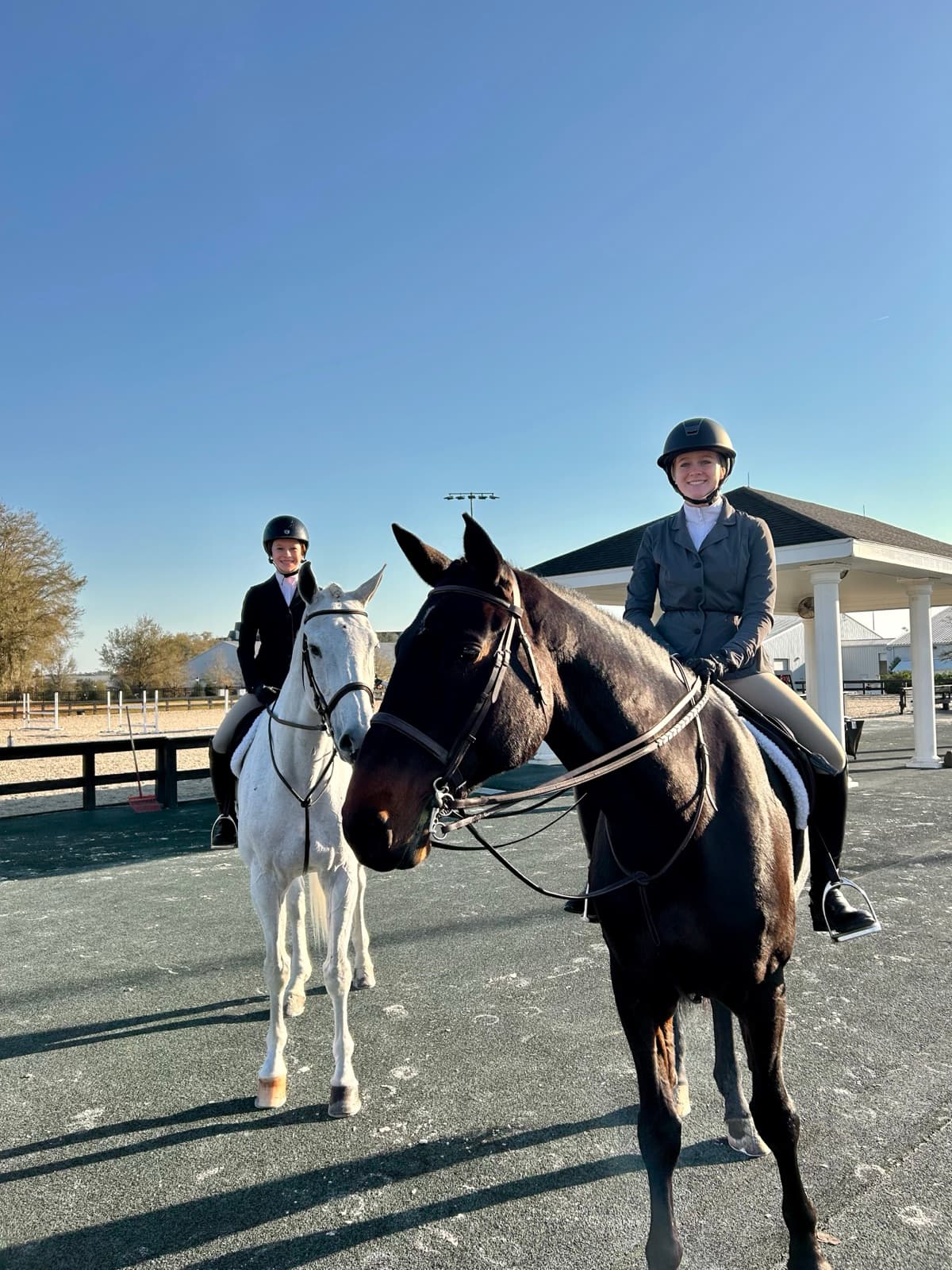 Tully and a barn mate on their horses waiting to enter the ring at a show.